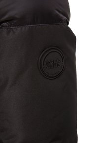 Black jacket section featuring smooth nylon material, a circular embossed logo reading "POLO CLUB," and the year "2012."