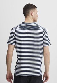 Men's short-sleeve T-shirt in navy and white horizontal stripes, soft cotton material, crew neck, with a straight hem and stitched accents.