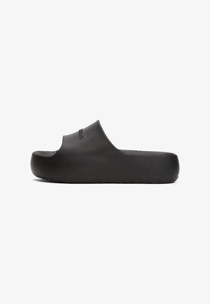 Black slide sandal with a molded design, smooth texture, open toe, and a thick sole. Marked with a brand logo on the upper side.