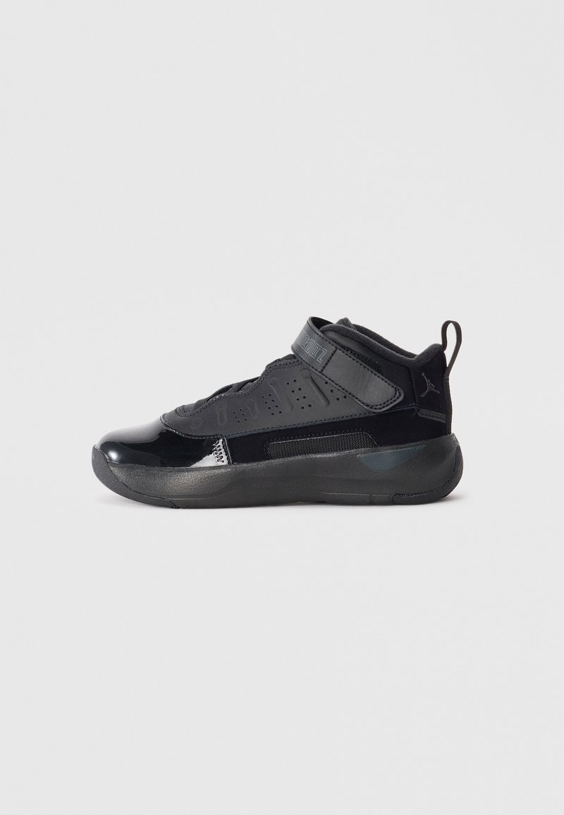 Black athletic sneaker with a high-top design, featuring glossy and matte textures, a Velcro strap, and perforated details for breathability.