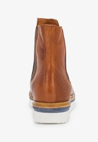 Brown leather ankle boot with a textured snakeskin pattern, elastic side panels, a white sole, and contrasting blue accent near the heel.