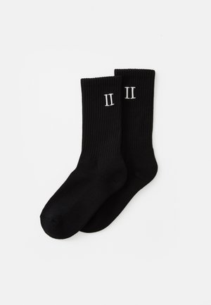 Black ribbed socks with white "II" printed on the side. The fabric appears smooth and elastic, designed for comfort and style.