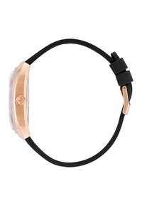 Montre en acier rose doré avec un cadran transparent et un bracelet en silicone noir. Dotée d'une couronne sur le côté et d'un design minimaliste.