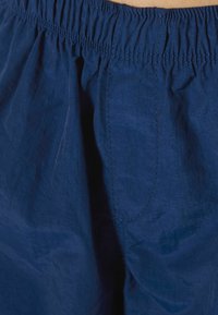 Navy blue elastic-waist shorts with a smooth texture and subtle sheen. Features a simple design and minimal stitching details.