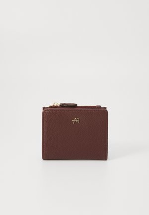 Burgundy leather wallet with a textured surface, featuring a gold-tone logo and a zip closure. Compact rectangular shape.
