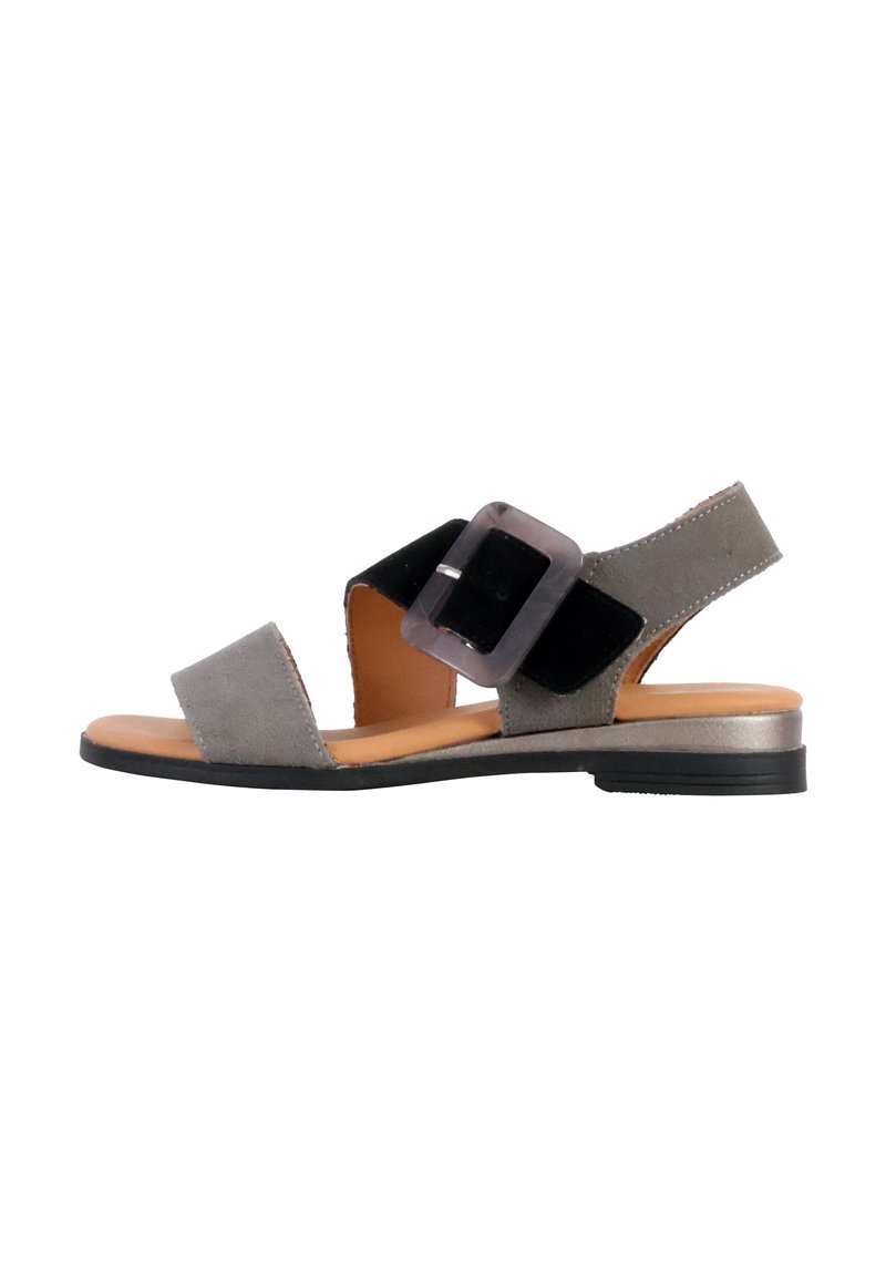 Gray suede sandal with black strap, decorative buckle, open toe, and a low, black sole. Features a smooth inner lining and minimalistic design.