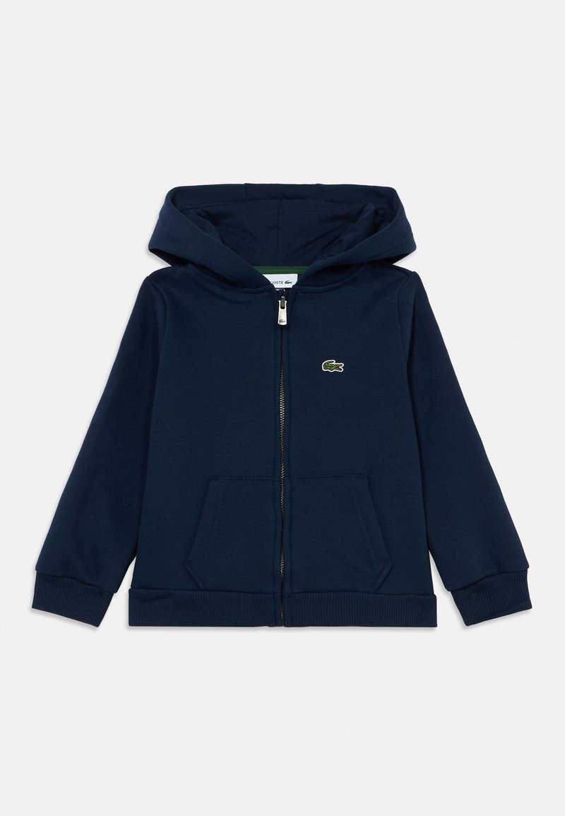 Navy blue zip-up hoodie made of soft fabric, featuring a kangaroo pocket, ribbed cuffs and hem, with a small green crocodile logo on the chest.
