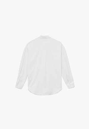 Chemise blanche à manches longues en tissu lisse. Dotée d'un col boutonné, d'un empiècement au dos et d'un ourlet arrondi. Boutons aux poignets.