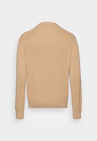 Pullover a coste beige con maniche lunghe, colletto rotondo e orlo aderente. Texture liscia con cuciture minime, progettato per una vestibilità rilassata.