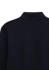 Dark navy polo shirt featuring a textured, woven pattern with a solid collar. The fabric has a subtle sheen and soft finish.