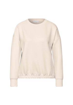 Sudadera de color beige claro con cuello redondo, hombros caídos y cintura elástica. Fabricada con una tela suave y texturizada, con mangas largas.