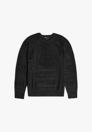 Un pull noir en tricot présentant diverses textures et motifs, avec un col rond et des manches raglan. Fabriqué à partir d'un tissu doux et léger.