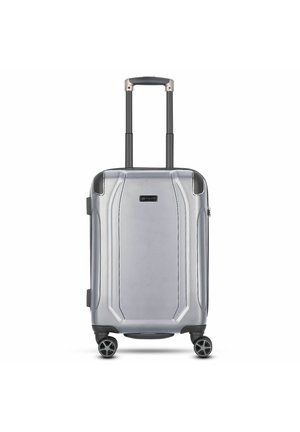 Silver hard-shell carry-on suitcase with a textured surface, dual-rolling wheels, and an extendable handle. Notable design lines on the body.