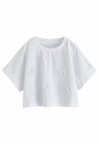 Weißes Baumwoll-Crop-Top mit kurzen Ärmeln, aus weichem Stoff und dekorativen, durchsichtigen Blumenapplikationen auf der Vorderseite. Klassischer Rundhalsausschnitt.