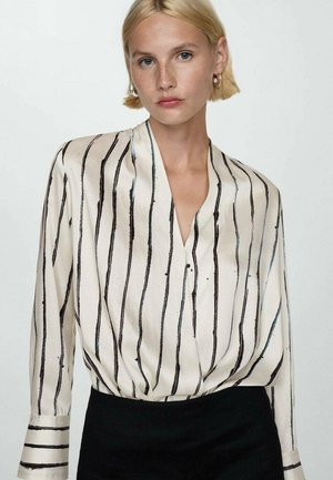 Blusa di seta con scollo a V profondo, strisce verticali nere su sfondo crema e maniche con polsini. Design semplice ed elegante.