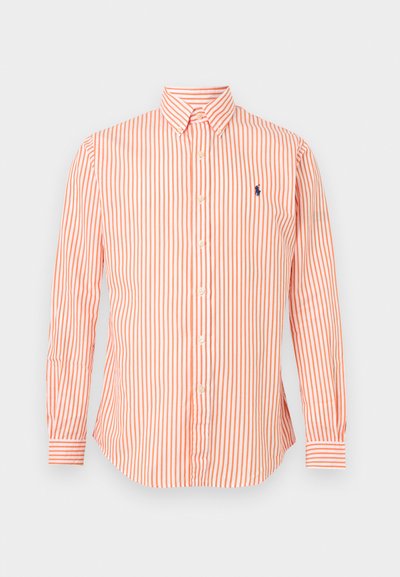 Πουκάμισο με μακριά μανίκια και κουμπιά, με πορτοκαλί και λευκές κάθετες ρίγες και μικρό ναυτικό κεντητό λογότυπο στο αριστερό στήθος.
