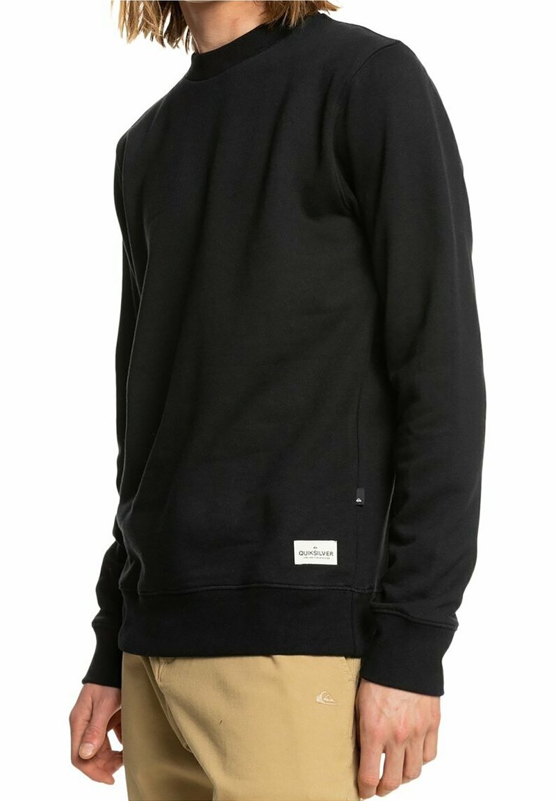Felpa nera in misto cotone, con scollo rotondo, maniche lunghe, polsini a costine e etichetta con il logo Quiksilver all'orlo.