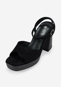 Sandalias de tacón alto de ante negro con punta abierta redondeada, dos correas delgadas en el tobillo y un tacón de bloque texturizado. Talla marcada como 36.