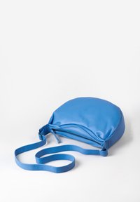 Borsa a tracolla blu in pelle con forma arrotondata, chiusura con zip e tracolla regolabile, caratterizzata da una texture liscia e un design minimalista.