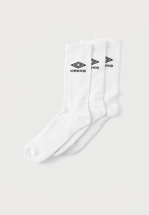 Hvide sportsstrømper lavet af bomuldsblanding. Ribbet tekstur med sort "Umbro" logo trykt på siden. Pakke med tre par.