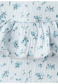 Light blue floral-patterned fabric with a textured weave. Features a ruffled hem with delicate stitching and varying shades of blue.