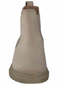 Botín de piel beige hasta el tobillo con paneles laterales elásticos, punta redonda y suela de goma marrón. Textura suave y detalles de diseño minimalistas.