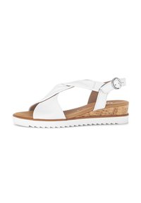 White wedge sandals with crisscross straps, cork accent heel, rubber sole, adjustable ankle strap, and smooth leather texture.