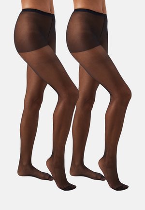 Mustad mustad sukad sujuva tekstuuri, kõrge vöökoht ja õmblusteta disain, shown kahel jalal, mis on asetatud kõrvuti.