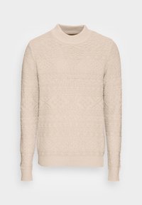 Beige stickad tröja med hög krage, som har texturerade mönster och ribbade ärmslut och nederkant. Chunky stickad tyg ger en mysig look.