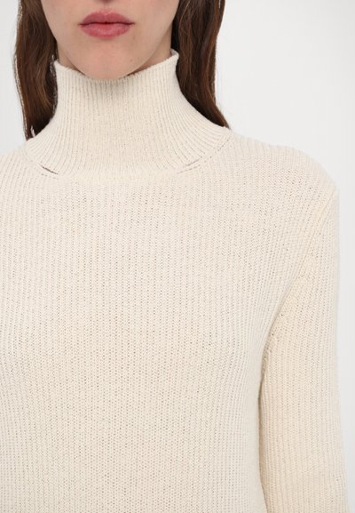 Pulover bej cu guler înalt, cu o croială fitted. Fabricat dintr-un material tricotat texturat, având mâneci lungi.