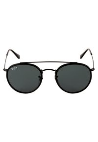 Round black sunglasses with dark lenses, metal frame, and thin temples. Features Ray-Ban logo on the left lens. Minimalist design.