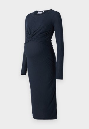 Abito premaman a coste in un blu navy scuro, con maniche lunghe, dettaglio intrecciato in vita e orlo a ginocchio. Tessuto morbido, design aderente.