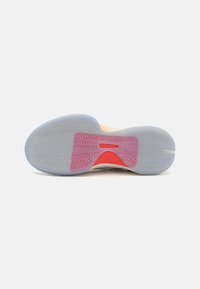 Basketball shoe outsole, featuring a translucent blue rubber with a herringbone pattern and a bright red accent at the midsole.