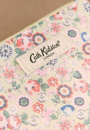 Floral-patterned fabric with pastel pink, blue, and green flowers and a stitched Cath Kidston London brand label.