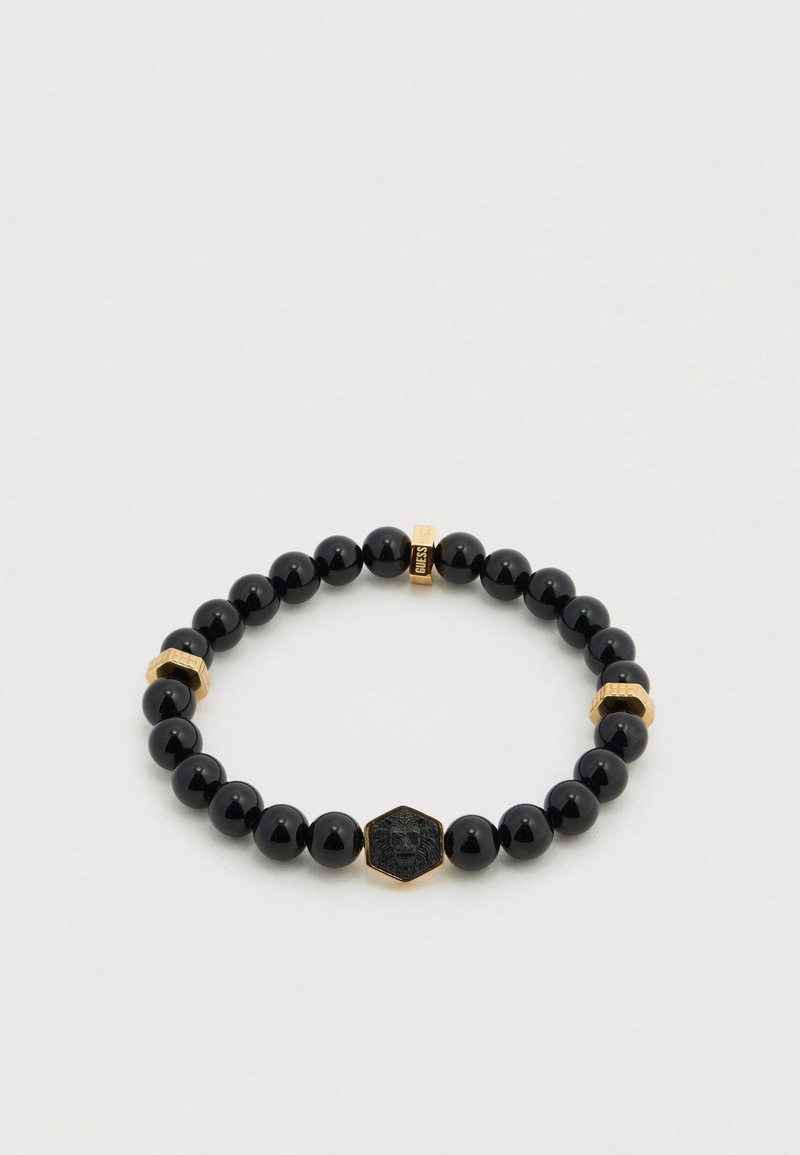 Μαύρο βραχιόλι με χάντρες, που διαθέτει λείες γυαλιστερές χάντρες, χρυσές λεπτομέρειες και ένα εξαγωνικό μενταγιόν με λεπτομερή σχεδιασμό λιονταριού.