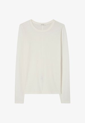 Pikad varrukad särk heledast valgest, pehmest kangast. Ümar kaelus minimaalsete õmblustega, lõdva istuvusega ja kerge tekstuuriga.