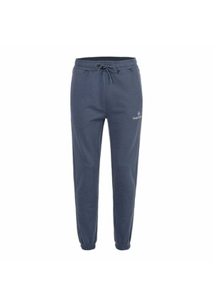 Pantalons de jogging bleu marine avec ceinture élastique, cordon de serrage, poignets aux chevilles, et petit logo blanc "Sergio Tacchini" sur la cuisse gauche.