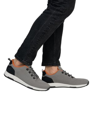 Gray mesh sneakers with a black back and orange accents. Features a textured design and lace-up front, set against a plain background.