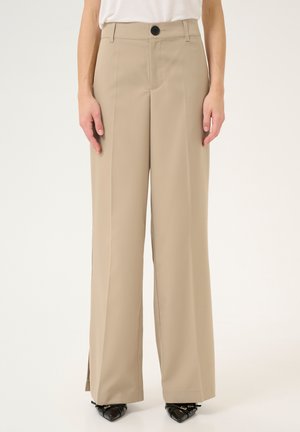 Beige high-waisted wide-leg trousers made of smooth fabric, featuring a button closure, pressed pleats, and side slits at the hem.