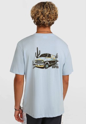 Light blue cotton t-shirt with short sleeves, featuring a graphic of a van, cacti, and text on the back. Smooth texture, relaxed fit.