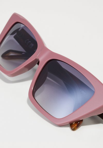 Pink plastic sunglasses with oversized square frames, gradient dark lenses, and a tortoiseshell accent on the temple.