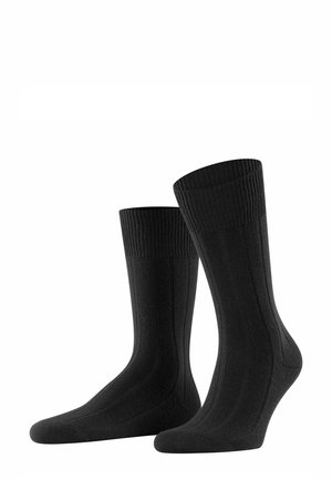 Black ribbed socks with a smooth finish, featuring a cushioned sole and reinforced toe area. Simple design without patterns or accents.