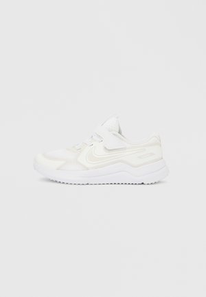 Baltos spalvos „Nike“ sportbačiai iš tinklinio ir sintetinio audinio. Turi paminkštintą apykaklę, reguliuojamą dirželį ir tekstūruotą pado dalį, skirtą sukibimui.