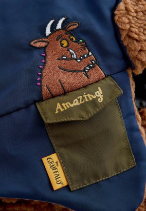 Navy fabric featuring an embroidered Gruffalo character, with a brown plush accent. Green pocket reads "Amazing!" and includes a label.