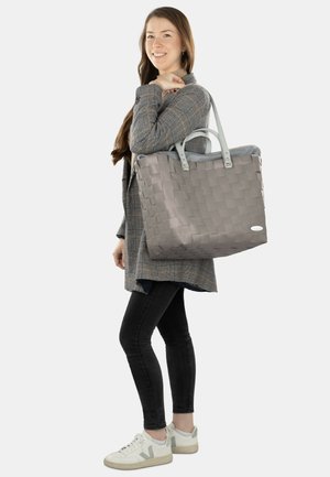 Gray woven tote bag with textured surface, two light gray handles, and a soft inner lining. The bag is large and rectangular in shape.