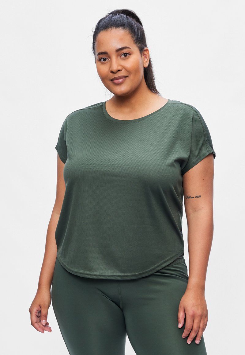 Green short-sleeve athletic top made of textured fabric, featuring a rounded neckline and a relaxed fit. Paired with matching green leggings.