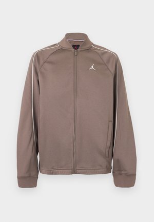 Veste de sport marron zippée avec passepoils blancs sur les manches et petit logo Jumpman blanc sur la poitrine gauche, avec poignets et col côtelés.