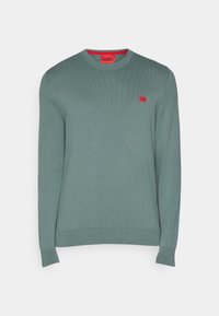 Ljusgrön tröja med rund halsringning, ribbade ärmslut och nederkant. Har en liten röd logotyp på bröstet. Mjuk tygkänsla.