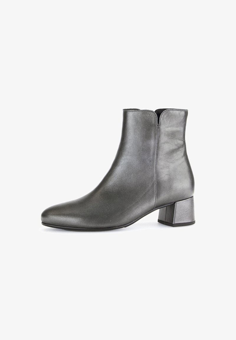 Black leather ankle boots with a rounded toe and a low block heel. Smooth texture and minimalistic design with a zip closure at the back.