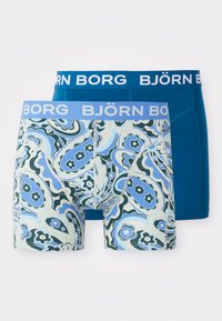 Pacote com dois boxers, um com estampa de paisley azul e outro em azul sólido. Ambos têm uma cintura elástica macia com a marca "BJÖRN BORG".